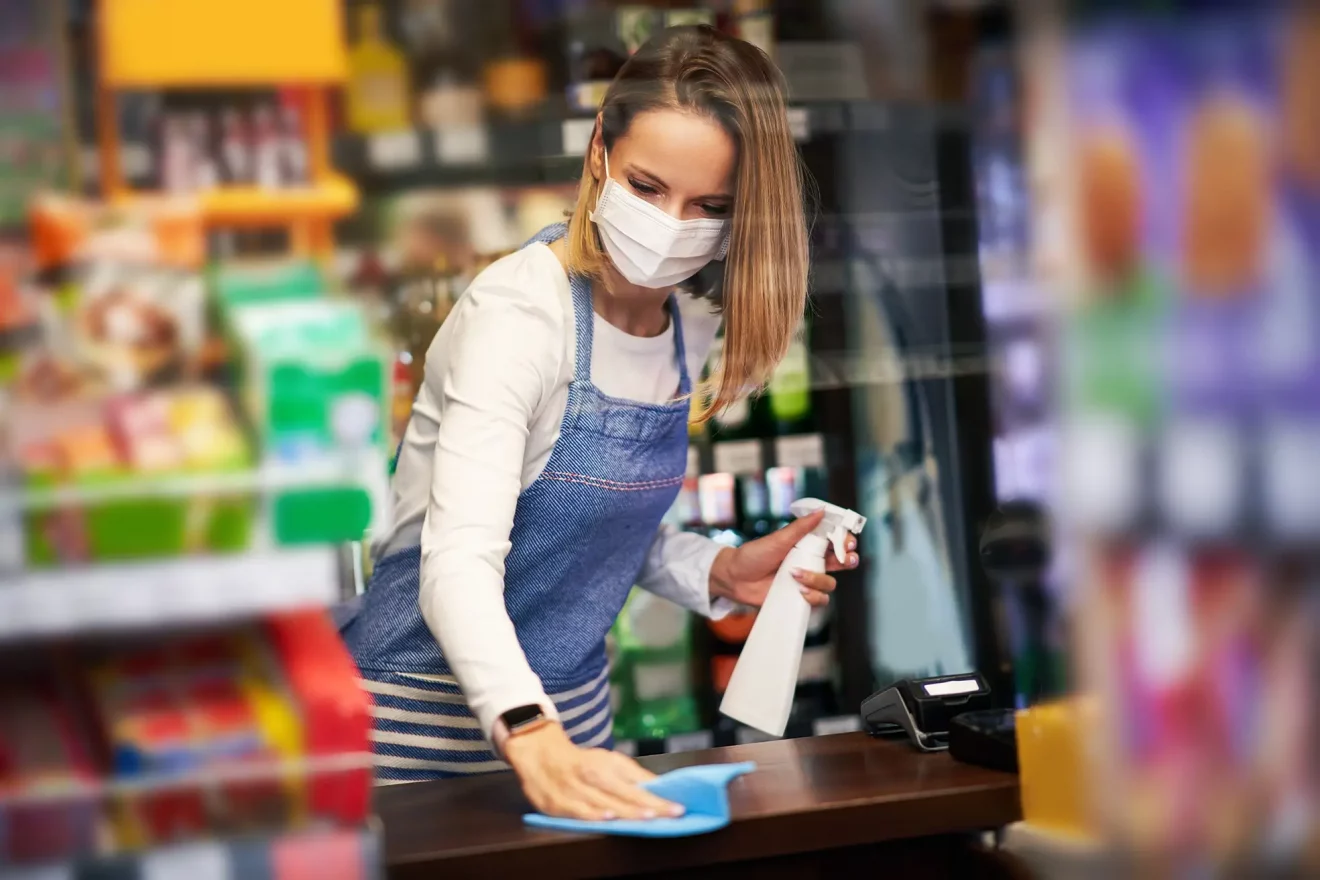 shop-assistant-disinfecting-surfaces-grocery-store